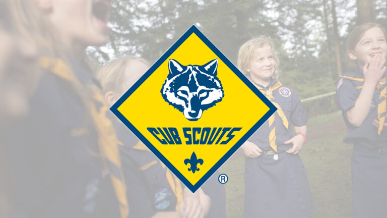 Cub Scouts logo over a photo of scouts at an outdoor gathering
