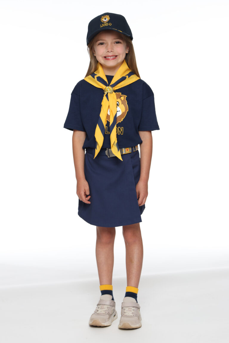 A Lion Cub Scout in navy uniform with yellow neckerchief